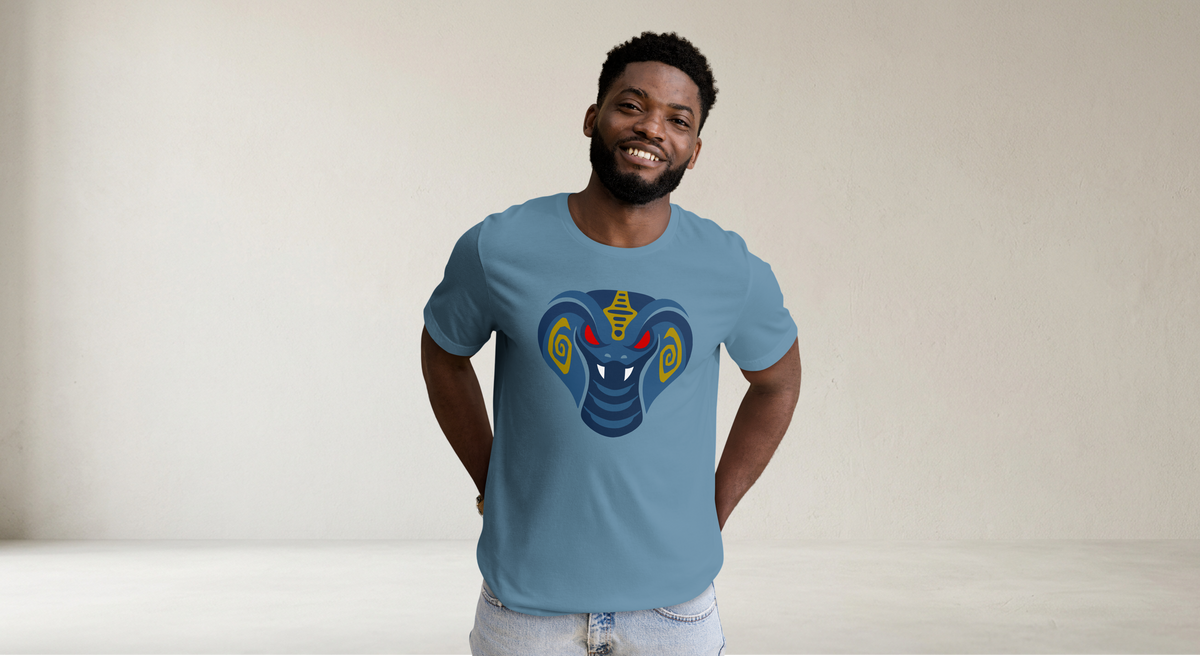 Fashionable male model wearing steel blue 100% airlume cotton t-shirt featuring fan-made cult-classic scaley snake king design. Item is a BRKDrip AFOL essentials shirt with a modern elemental brick masters aesthetic.