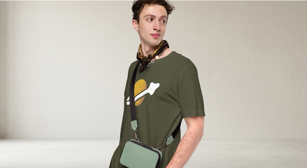Fashionable male model wearing olive green 100% airlume cotton t-shirt featuring classic fan-made OG yellow planet with spaceship classic space logo design. Item is a BRKDrip AFOL essentials shirt with a vintage space building blocks aesthetic.
