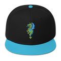 Front-facing view of black flat bill hat with a bright blue bill and strap featuring embroidered dragon master remix design with matching bright blue wings. Item is a BRKDrip AFOL Headgear classic snapback with a vintage castle building blocks aesthetic.