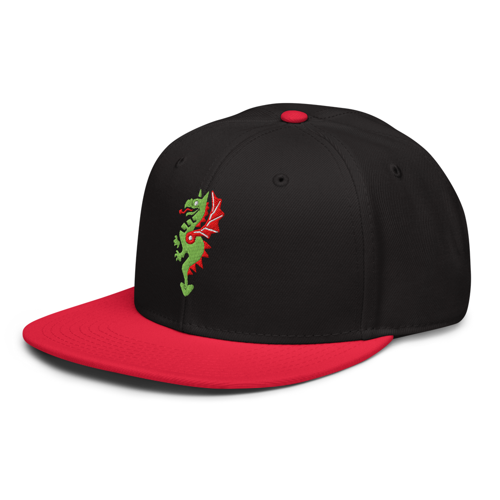 Side profile of black flat bill hat with a bright red bill and strap featuring embroidered dragon master remix design with matching bright red wings. Item is a BRKDrip AFOL Headgear classic snapback with a vintage castle building blocks aesthetic.