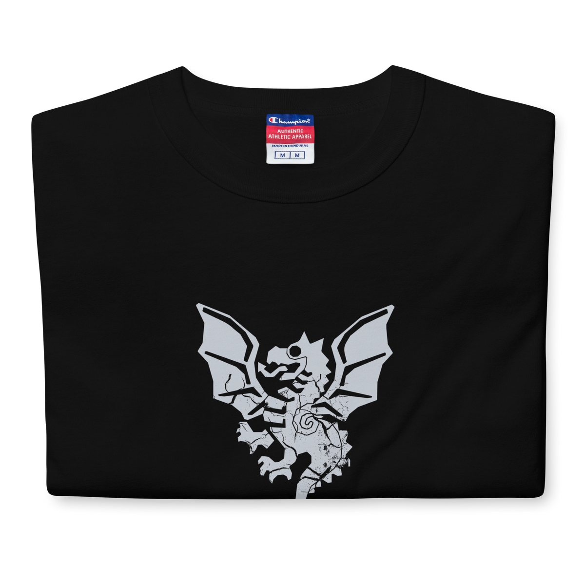 Folded black heavyweight, 100% cotton luxury Champion© t-shirt featuring aged dragon master emblem and text "EST. 1988" indicating the year the faction was first introduced to the brick universe. Item is a BRKDrip Heritage Collection luxury shirt with a vintage castle building block aesthetic.