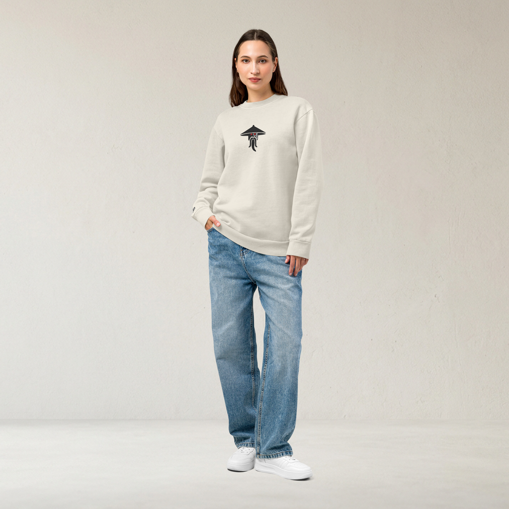 Fashionable female model wearing an off-white lunar rock tri-blend fleece sweatshirt featuring a classic fan-made evil sensei with red eyes design embroidered across the front and setshirt number 70725 on the sleeve. Item is a BRKDrip Limited Edition Cozy Wear Sweatshirt with a modern elemental brick master aesthetic.