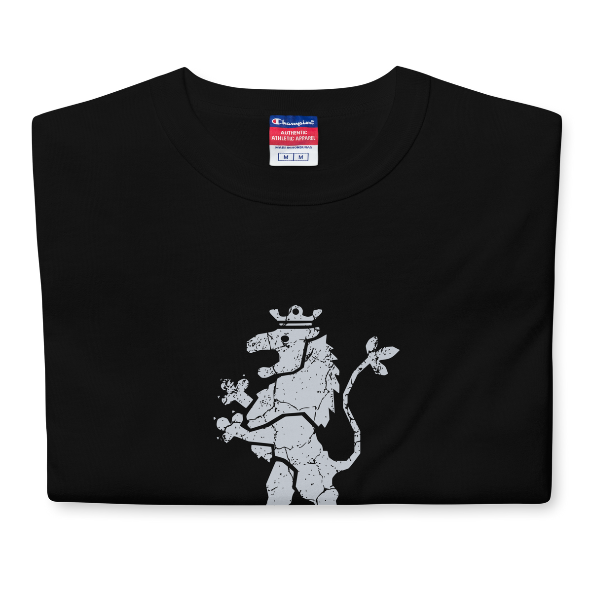 Folded black heavyweight, 100% cotton luxury Champion© t-shirt featuring aged lion emblem and text "EST. 1984" indicating the year the faction was first introduced to the brick universe. Item is a BRKDrip Heritage Collection luxury shirt with a vintage castle building block aesthetic.